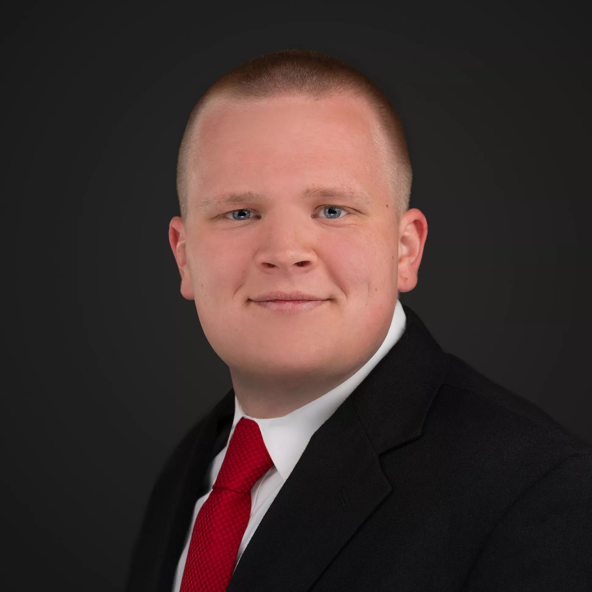 Addison Moulds, Seniors Real Estate Specialist, in a dark suit and red tie