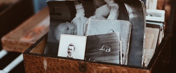A box of old family photographs kept from a lifetime of belongings